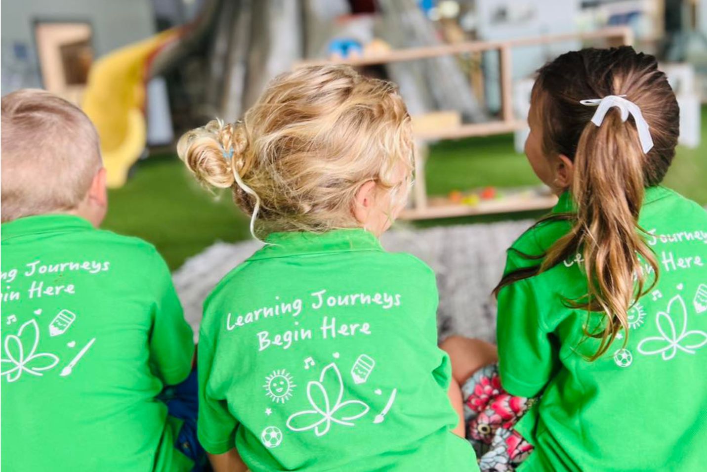 kindergarten children with branded green leaves shirt
